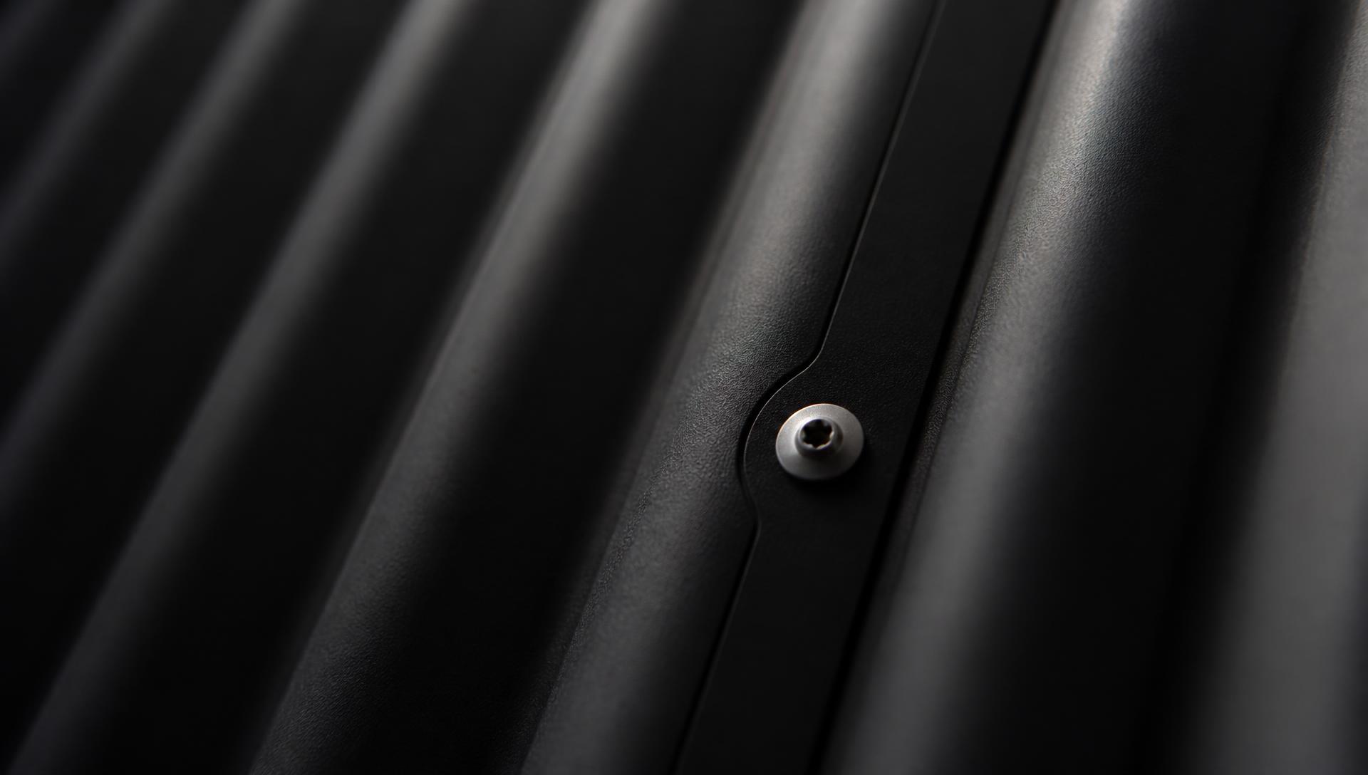 Matte-black corrugated steel panel and stainless fastener