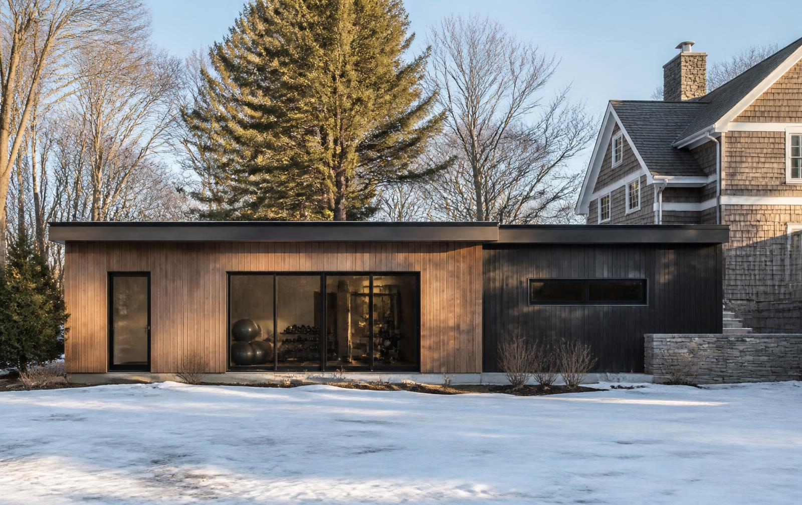 Finished exterior cladding matched to the house it sits beside, in late winter light